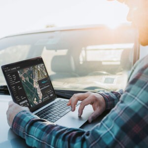 man using laptop with PigView Desktop in a truck