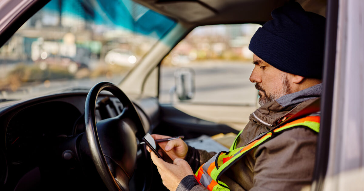 man using Pigview Mobile pig tracking software in truck
