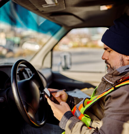 man using Pigview Mobile pig tracking software in truck