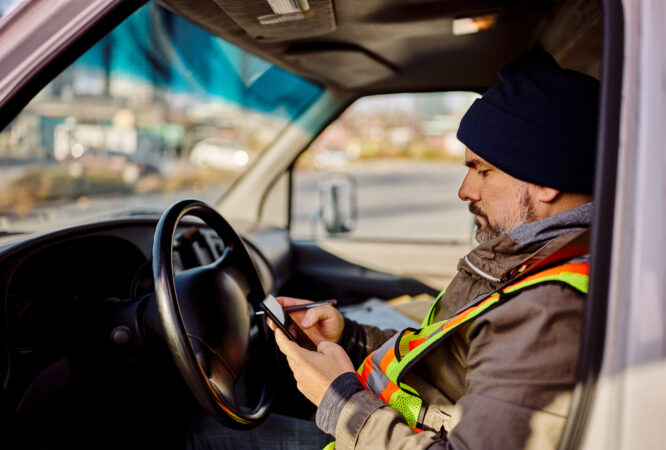 man using Pigview Mobile pig tracking software in truck