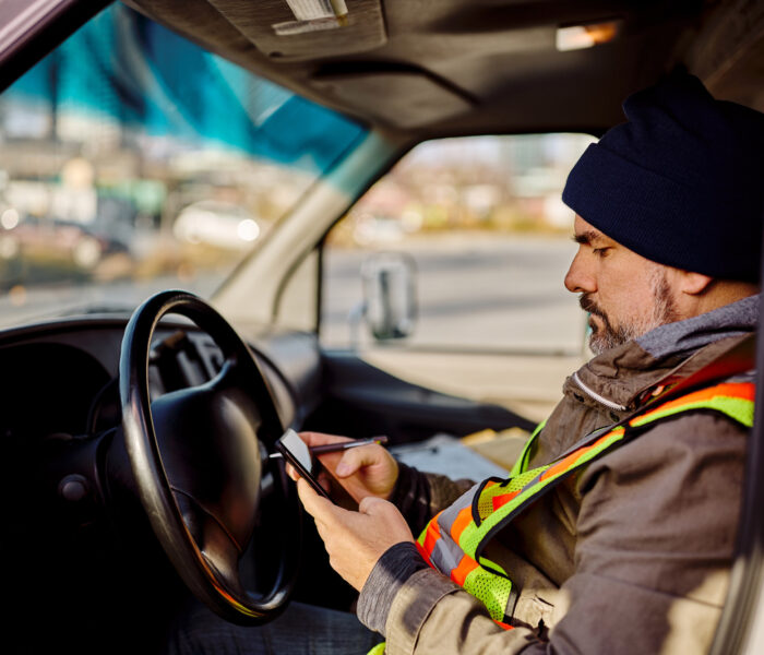 man using Pigview Mobile pig tracking software in truck
